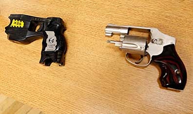 Tulsa World via AP, File<br>
A Taser, left, and handgun are displayed at a news conference in Tulsa similar to the weapons in possession of a Tulsa County reserve deputy who killed an unarmed suspect in Tulsa earlier this month.