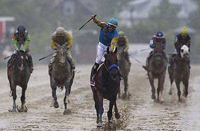 Patrick Semansky/The Associated Press<br>American Pharoah, ridden by Victor Espinoza, center, wins the 140th Preakness Stakes horse race at Pimlico Race Course, Saturday in Baltimore.