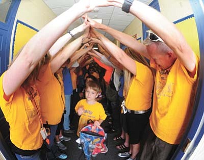 








Les Stukenberg/The Daily Courier<br>Teachers and staff send students home through a human bridge on the last day of school at Miller Valley School in Prescott Thursday morning.