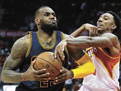 David Goldman/The AP<br>
Cavaliers forward LeBron James is fouled by Hawks guard Jeff Teague during the second half Friday, May 22, in Atlanta.