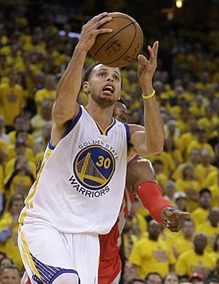 Ben Margot/The Associated Press<Br>Warriors guard Stephen Curry shoots against the Rockets Wednesday night in Oakland.