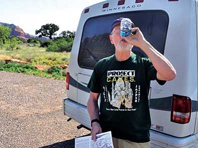 Vyto Starinskas/Courtesy photo<br>
Rick Hinterthuer of Fayetteville, Arkansas, takes a drink of water and packs several more bottles in his backpack before hiking the Doe Mountain Trail in Sedona.