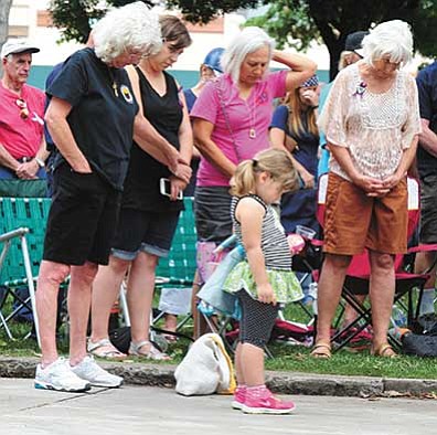 Les Stukenberg/The Daily Courier<br>
People young and old observe a moment of silence during the City of Prescott's commemoration Tuesday of the Granite Mountain Hotshots, 19 members of which were tragically killed on June 30, 2013.