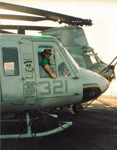 Jim Weber, above, during a deployment, in the seat of a Marine UH-1 Huey he helped maintain. Weber, today below said technicians were rewarded with flights where they piloted the helicopters they worked on. (Courtesy photo)