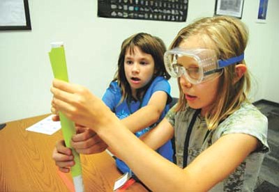 Les Stukenberg/The Daily Courier<br>Lizzy Saunders, from Phoenix, and Katelyn Denny, from Prescott, make their rocket as part of a new STEM program called GEEK (Girls Exploring Engineering Kamp) at Yavapai College CTEC Campus.