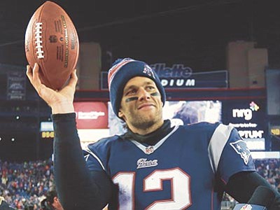 Elise Amendola, File/The AP<br>
New England Patriots quarterback Tom Brady holds up the game ball after the NFL divisional playoff game 
Jan. 10, 2015, against the Baltimore Ravens.