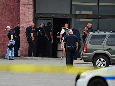 John Partipilo/The Tennessean via AP<br>
Police work the scene of a reported shooting in Nashville, Tenn., Wednesday, Aug. 5. A suspect wielding a hatchet and a gun inside a Nashville-area movie theater died after exchanging gunshots with a police team.