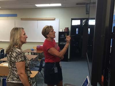 Les Bowen/The Daily Courier<br>Granite Mountain School Principal Teresa Bruso observes as fifth-grade teacher Mary Ticer demonstrates the use of an interactive television in her classroom.