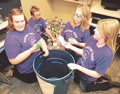 Les Stukenberg/The Daily Courier<br>Canyon View Student Council members Katie Medford, Kenny Heineman, Hannah Barrett and Khayle Mathwig count the items collecte so far in the school’s food drive. The drive runs until Aug. 24 and so far they have collected 296 food items.