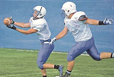 Matt Hinshaw/The Daily Courier<br /><br /><!-- 1upcrlf2 -->Prescott's Luke Hein, left, catches a pass while Juan Lopez tries to block him during team practice Monday afternoon August 10 at Prescott High School.