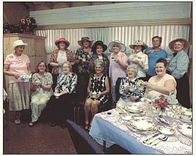 Monday Club members raise their tea cups in a salute to the women’s group that formed in 1895 and has been promoting civic improvement causes in Prescott ever since.