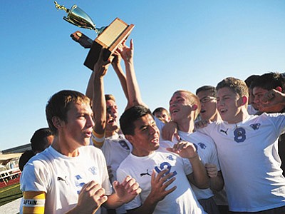 Les Stukenberg/The Daily Courier, file<br>
Chino Valley players celebrate with the trophy as the Cougars defeated Blue Ridge 4-0 to win the AIA Division 4 State Championship Nov. 8, 2014, at Campo Verde High School in Gilbert.