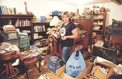 Les Stukenberg/The Daily Courier<br>Prescott resident Colleen Carr still has a lot of stuff to look through, even after the American Pickers crew stopped by, in the home she inherited from her uncle Victor Buck. Carr said she liked the American Pickers experience and they paid her about $2,100 for the items they bought on the show that aired on August 19.