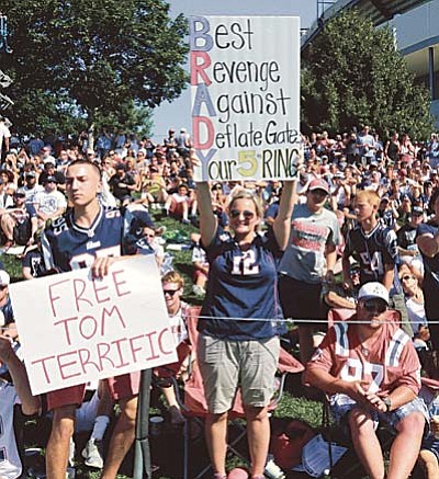 In this July 31, 2015, file photo, New England Patriots fans hold signs supporting quarterback Tom Brady during a team practice in Foxborough, Mass. A federal judge deflated "Deflategate" Thursday, Sept. 3, 2015, erasing New England quarterback Tom Brady's four-game suspension for a controversy that the NFL claimed threatened football's integrity. U.S. District Judge Richard M. Berman said NFL Commissioner Roger Goodell went too far in affirming punishment of the Super Bowl winning quarterback (AP Photo/Charles Krupa, File)