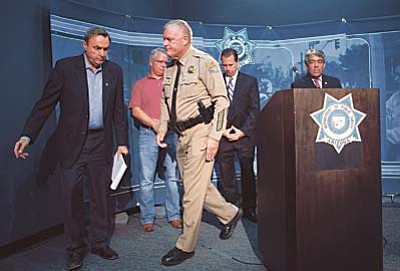 David Wallace/The Arizona Republic via AP<br /><br /><!-- 1upcrlf2 -->Colonel Frank Milstead, center, Director of Department of Public Safety, walks off after speaking during a press conference to announce the arrest of a suspect in the Phoenix freeway shootings, at DPS headquarters in Phoenix on Friday, Sept. 18, 2015. He is flanked by DPS spokesman Bart Graves, from left, Maricopa County Attorney Bill Montgomery, ATF Special Agent in Charge Tom Attteberry and U.S Marshall for the District of Arizona David Gonzales. <br /><br /><!-- 1upcrlf2 -->