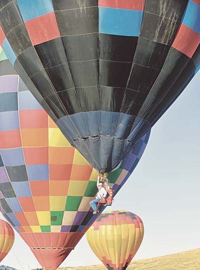 Matt Hinshaw/The Daily Courier<br /><br /><!-- 1upcrlf2 -->A solo hot air balloon pilot begins his flight during the 5th Annual Prescott Valley Rotary BalloonFest Saturday morning in Prescott Valley.