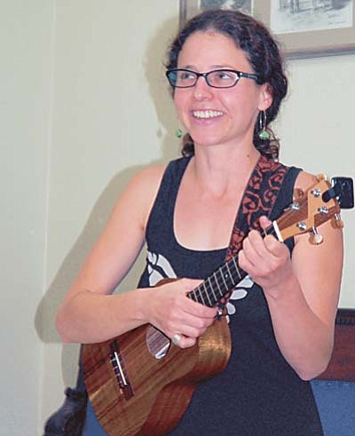 Sue Tone/The Daily Courier<br>Marieke Slovin performs three of her original story-to-song compositions at the High Noon Toastmasters Open House Sept. 9. She will play her music Friday from 7-10 p.m. at the Black Hole in Prescott.