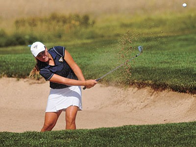 Les Stukenberg/The Daily Courier<br>
Embry-Riddle’s Trae Jones hits a sand shot onto the green during the ERAU Co-Ed Invite at Talking Rock Golf Club Monday morning.
