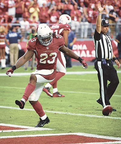 Ross D. Franklin/The AP<br>
Arizona Cardinals running back Chris Johnson celebrates a run against the San Francisco 49ers during the second half of Sunday’s game in Glendale.