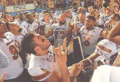 Arizona State quarterback Mike Bercovici, below, celebrates with teammate after they defeated UCLA in an NCAA college football game, Saturday, Oct. 3, 2015, in Pasadena, Calif. Arizona State won 38-23. (AP Photo/Mark J. Terrill)