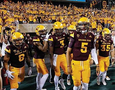 FILE - In this Sept. 12, 2015, file photo, Arizona State players get ready to run out onto the field for an NCAA college football game against Cal Poly in Tempe, Ariz. Arizona State was a trendy to pick to make the College Football Playoff headed into the season. After two shaky games, the Sun Devils have been nowhere close to living up to those lofty expectations. (AP Photo/Ross D. Franklin, File)