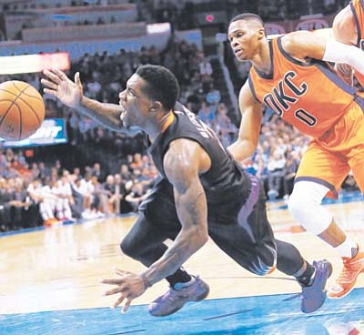 Phoenix Suns guard Eric Bledsoe loses the ball as he is fouled by Oklahoma City Thunder guard Russell Westbrook in the second quarter in Oklahoma City Sunday, Nov. 8. (AP Photo/Sue Ogrocki)