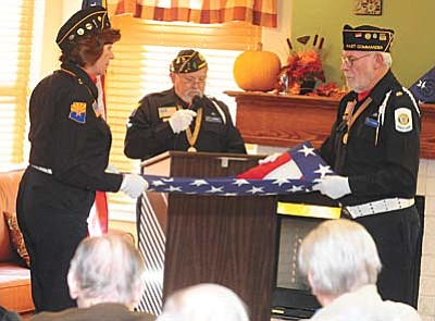 Les Stukenberg/The Daily Courier<br>American Legion Post 6 Honor Guard members Jan Bowles, Joe Weidner and Dan Tillmans perform a flag-folding explanation and ceremony.