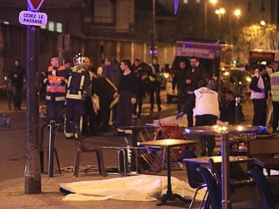 Thibault Camus/The AP<br>
Rescue workers and medics work by victims in a Paris restaurant, Friday, Nov. 13. Police officials in France reported a shootout in a Paris restaurant and an explosion in a bar near a Paris stadium. It was unclear if the events were linked.