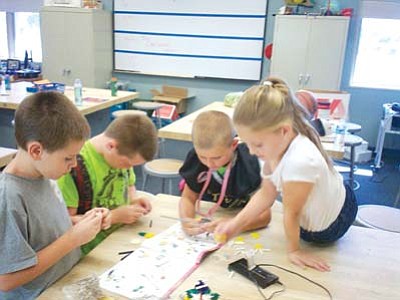 Coyote Springs Elementary School students work on a project that uses 21st Century Learning Skills. (Courtesy photos)