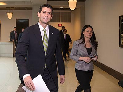 J. Scott Applewhite/The AP<br>
House Speaker Paul Ryan of Wisconsin walks to a news conference on Capitol Hill in Washington, Thursday, Nov. 19, as Republican lawmakers prepare to push legislation through the House erecting fresh hurdles for Syrian and Iraqi refugees trying to enter the U.S.