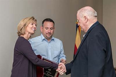 2016 President LeAnn Carver shakes hands with Immediate Past President Jeffrey Lewis while 2016 President-Elect Brad Bergamini looks on. (Courtesy of PAAR)