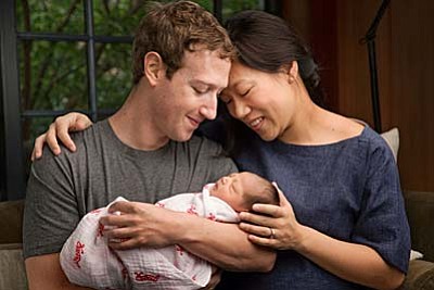 In this undated photo provided by Mark Zuckerberg, Max Chan Zuckerberg is held by her parents, Mark Zuckerberg and Priscilla Chan Zuckerberg. Facebook CEO Mark Zuckerberg and his wife announced the birth of their daughter, Max, as well as plans to donate most of their wealth to a new organization that will tackle a broad range of the world's ills. (Mark Zuckerberg via AP)