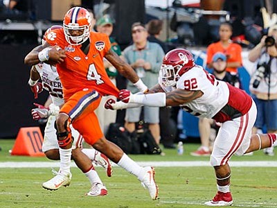 Joe Skipper/The AP<br>
Clemson quarterback Deshaun Watson (4) runs with the ball as Oklahoma defensive tackle Matthew Romar (92) attempts to stop him, during the first half of the Orange Bowl NCAA college football semifinal playoff game, Thursday, Dec. 31, in Miami Gardens, Florida.