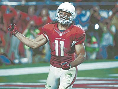 Arizona Cardinals wide receiver Larry Fitzgerald (11) celebrates his catch in the red zone to set up a game winning touchdown against the Green Bay Packers during the second half of an NFL divisional playoff football game, Saturday, Jan. 16, 2016, in Glendale, Ariz. The Cardinals won 26-20 in overtime. (AP Photo/Ross D. Franklin)