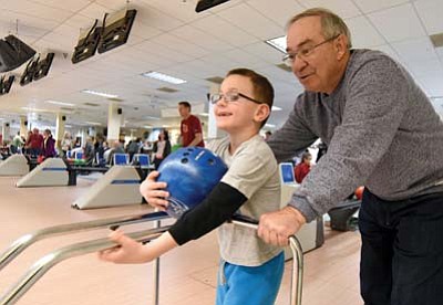 Big Dave helps his Little, Matt, set up a guide during Yavapai Big Brothers Big Sisters bowling event Saturday morning, Jan. 23, at Antelope Lanes in Prescott Valley. (Photos by Matt Hinshaw/The Daily Courier)