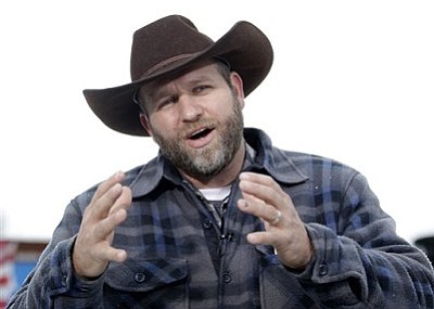 In a Tuesday, Jan. 5, 2016 file photo, Ammon Bundy speaks during an interview at Malheur National Wildlife Refuge, near Burns, Ore. Authorities said Tuesday, Jan. 26, 2016, that Bundy, leader of the armed Oregon group, has been arrested. Authorities say shots were fired during the arrest of members of an armed group that has occupied a national wildlife refuge in Oregon for more than three weeks. The FBI said authorities arrested Ammon Bundy, 40, his brother Ryan Bundy, 43, Brian Cavalier, 44, Shawna Cox, 59, and Ryan Payne, 32, during a traffic stop on U.S. Highway 395 Tuesday afternoon. (AP Photo/Rick Bowmer, File)