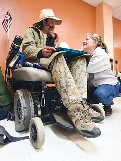 Matt Hinshaw/The Daily Courier<br /><br /><!-- 1upcrlf2 -->Veteran Outreach case manager Dawn Marie Hayden with Catholic Charities chats with homeless U.S. Navy veteran Nick about the problems with his wheelchair recently at the Salvation Army during their free breakfast for the homeless in downtown Prescott.