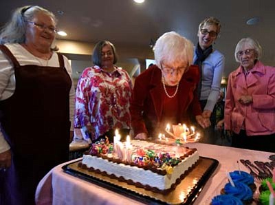 Edna Kelly, middle, blows out the candles on her 104th birthday cake while her friends from left, Nancy Coker, Janis Hearn, Karen Vree and Adonna Weatherly Saturday afternoon, Feb. 6, in Prescott Valley. (Matt Hinshaw/The Daily Courier)