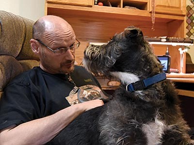Army Veteran Dennis Hutchinson spends time with his PTSD dog Shaggy at his apartment in Prescott.  Hutchinson was homeless for several years before the VA arranged for him to get housing.
