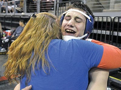 Matt Hinshaw/The Daily Courier<br>
Chino Valley’s Spencer Coffin gets a big hug from his mom Jaime after winning the AIA Division III State Championship Saturday night at the Prescott Valley Event Center.