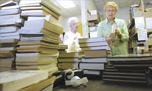 Courier/Les Stukenberg
Barbara Houser sorts through donated books Monday getting them ready for sale at the Friends of the Library’s book store at the Prescott Public Library.