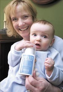 Courier/Nathaniel Kastelic
Jeanine Wood holds her 7-month-old son Sam and a bottle of Prolief by Arbonne International Friday morning explaining that the cream helped her tremendously during postpartum depression.