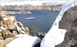 Courier/Nathaniel Kastelic
Snow begins to melt off granite rocks, trickling into Watson Lake as the sun makes an appearance Sunday afternoon in Prescott.