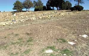 Courier/Nathaniel Kastelic
This is the spot, above, in the Pioneers¹ Home Cemetery where the former Lincoln County, N.M., sheriff and others dug up and took bones that they hope belong to John Miller, who claimed to be Billy the Kid. The only authenticated photo of Billy the Kid is at left.