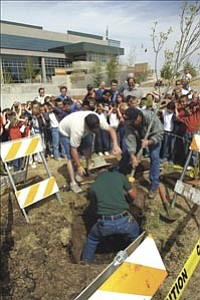 Prescott Valley parks employees, Jason Elmer, Gilbert Garcia and Fred Stoneburner plant a tree as children from Franklin Phonetic School and Prescott Valley Elementary watch. The tree planting near the Civic Center, is part of Earth Day weekend celebrations.

Courier/Jo. L. Keener