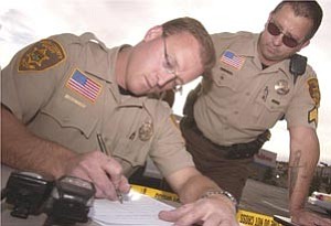 Courier file/Les Stukenberg

Deputy Victor Dartt fills out some paperwork as Sgt. Bill Suttles looks on before the two YCSO deputies take part in the zero tolerance campaign along Highway 69 from Prescott all the way to Interstate 17.