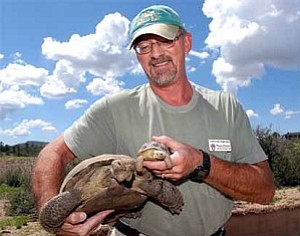 Courier/Jo. L. Keener
Wayne Fischer of the Heritage Park Zoo shows a full-size and smaller desert tortoise Wednesday in Prescott. Fischer will teach a new course, herpetoculture, at Yavapai College. The course is the study of reptiles and amphibians and will educate the owners of the special needs of reptiles.