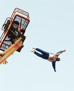 Stuntman Robert ³Spanky² Spangler jumps from a 120-foot construction platform, free falls and is assisted by his crew after a successful landing Saturday during an end-of-summer event at the Prescott Valley Entertainment District.
Courier photo/Jo. L. Keener
