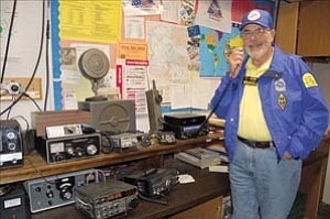 Courier/Lorin McLain

Yavapai Amateur Radio Club President John Broughton demonstrates a new radio sitting alongside equipment dating back to WWII.