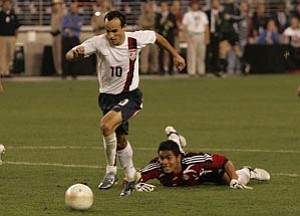 AP Photo/Ross D. Franklin --- United States forward Landon Donovan, left, gets past Mexico goalkeeper Oswaldo Sanchez for a late goal in the second half of their exhibition soccer game on Wednesday in Glendale. The United States defeated Mexico 2-0.